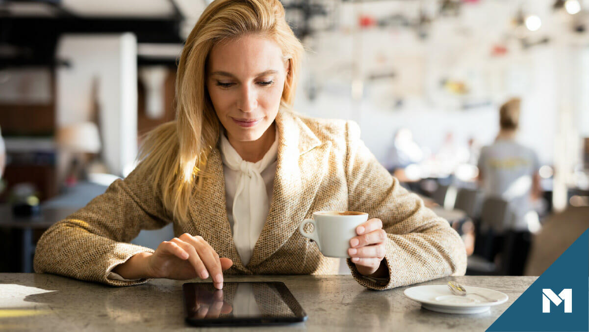 Woman investor checking loan status on tablet in cafe