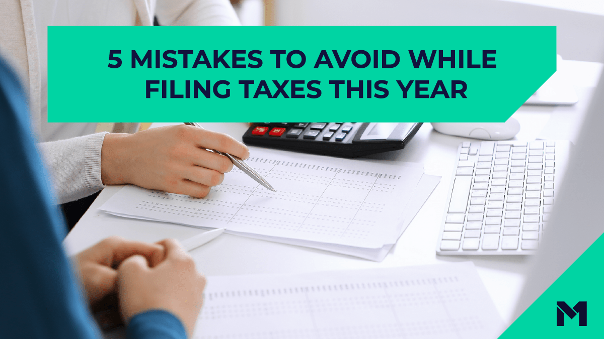 The title "5 mistakes to avoid while filing taxes this year" is on top of a photo of people's hands working with papers at a desk .