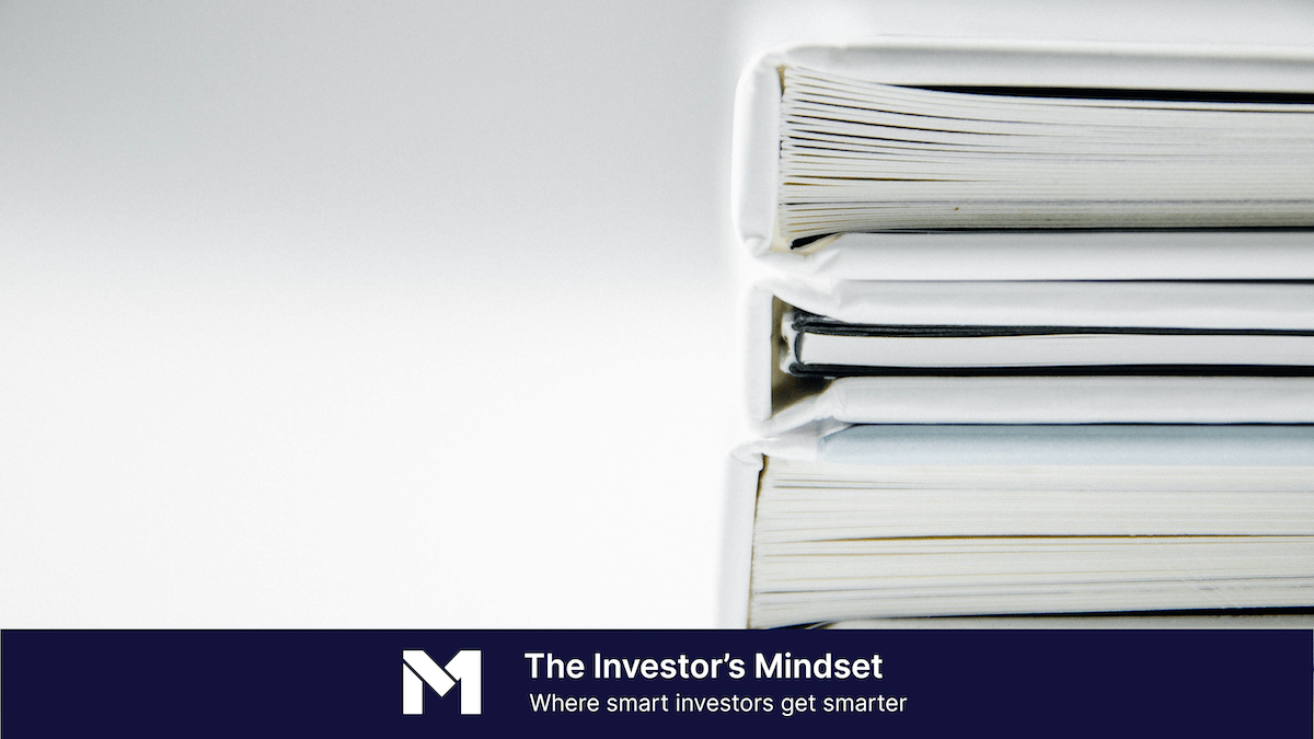 Image showing a stack of white binders full of documents and a banner along the bottom with the text "The Investor's Mindset, where smart investors get smarter."
