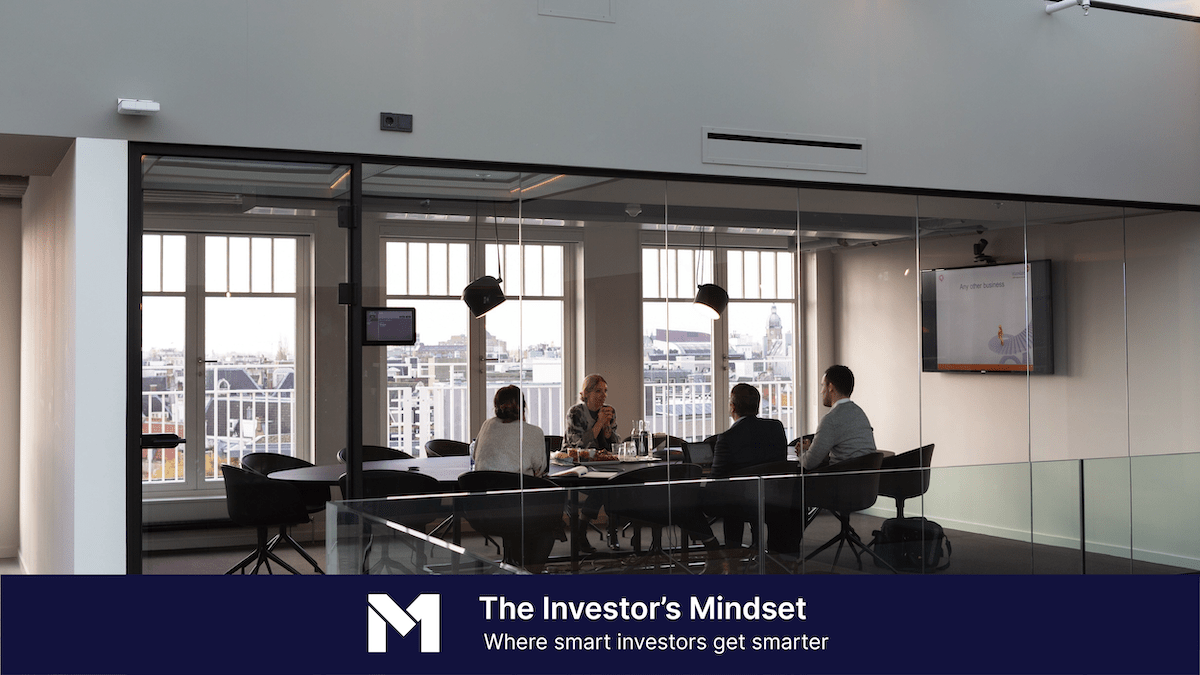 Group of business professionals in an office meeting room sitting around a conference table