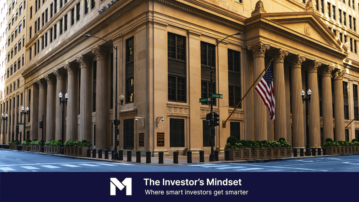 High rise building with the American flag flying outside, with banner text that reads "The Investor's Mindset, where smart investors get smarter"