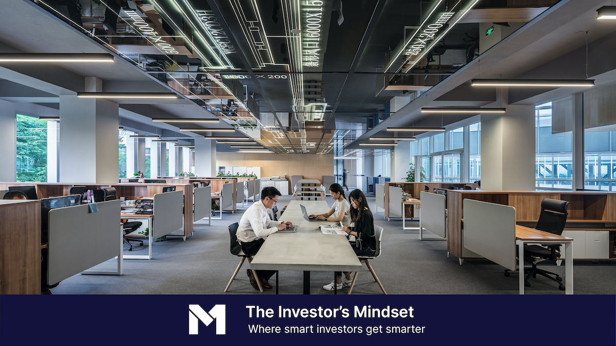 Business people sitting at desks in an open-concept office