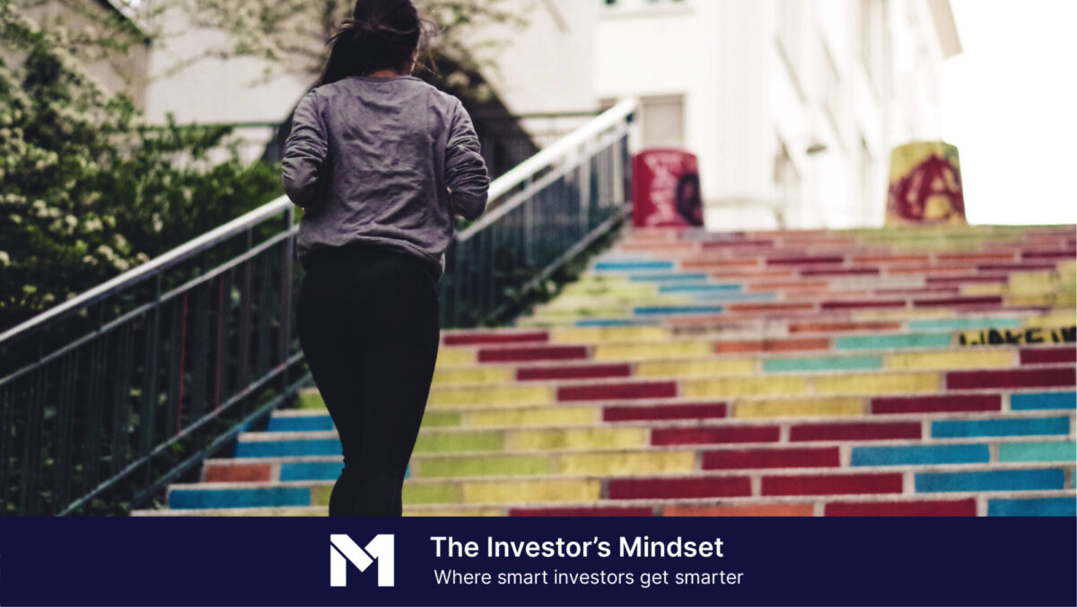 Woman in workout clothes running up colorful staircase, with banner text that reads "The Investor's Mindset, where smart investors get smarter"