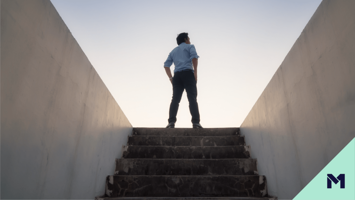 Businessman standing at the top of a staircase