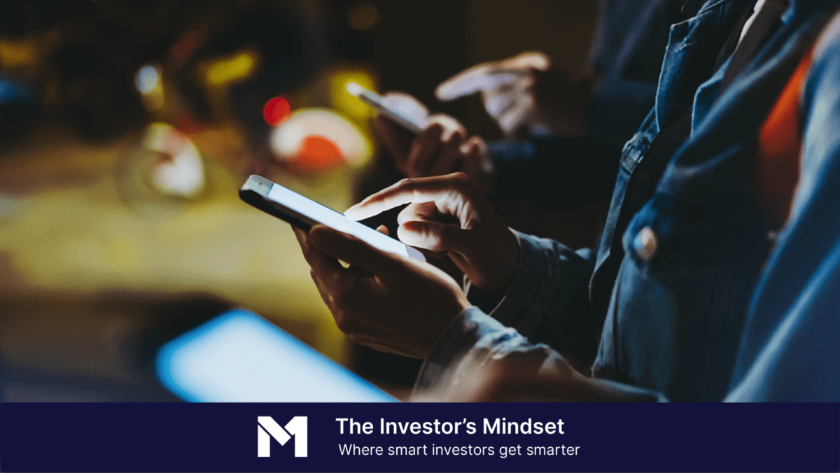 Group of investors using smartphones with banner text that reads "The Investor's Mindset, where smart investors get smarter"