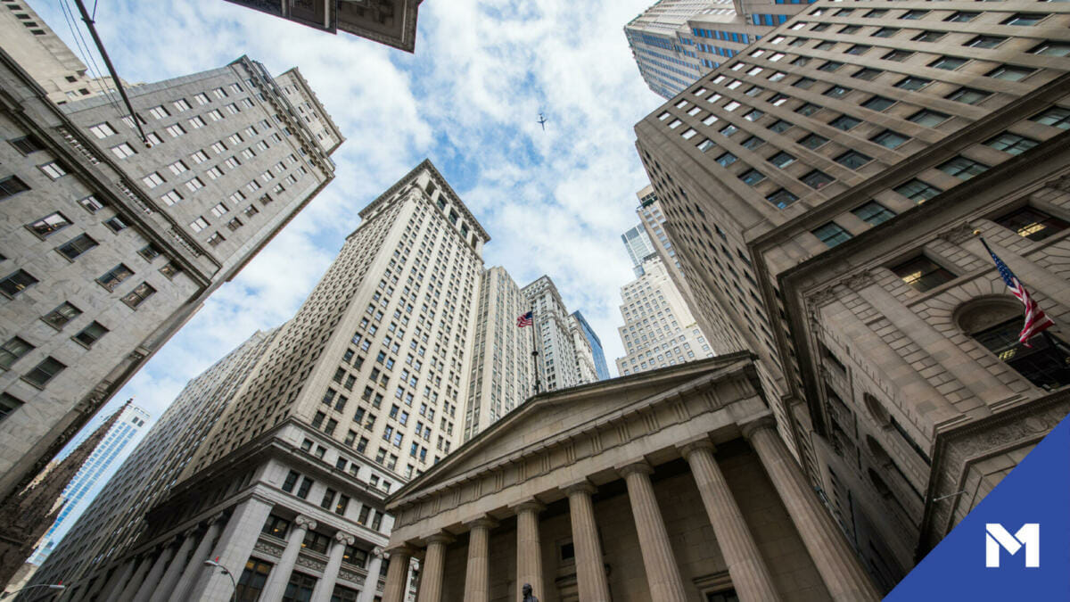 View looking up at large buildings all around from the ground