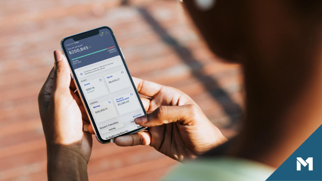 Person using the M1 iOS app to check their net worth and recent banking transactions