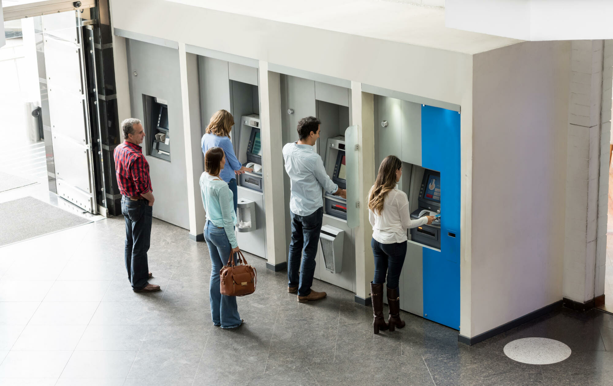 People withdrawing cash at an ATM